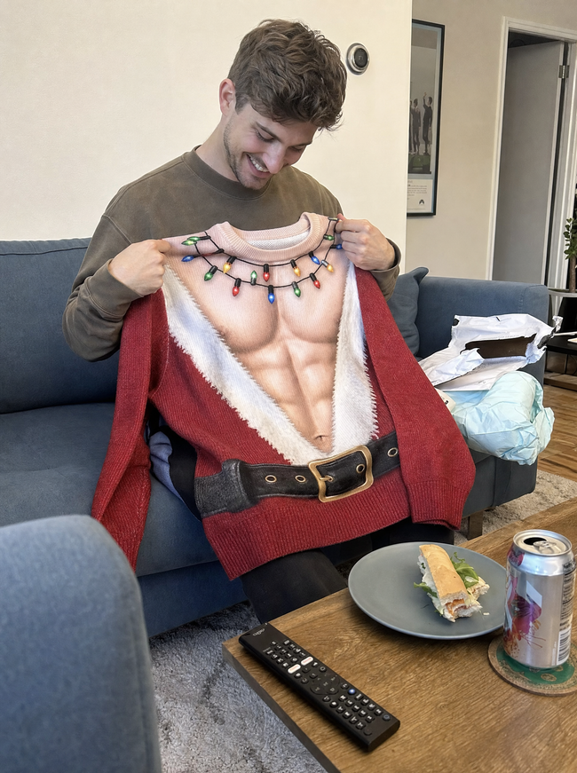 Emma's boyfriend holding the Azyro Christmas Sweater